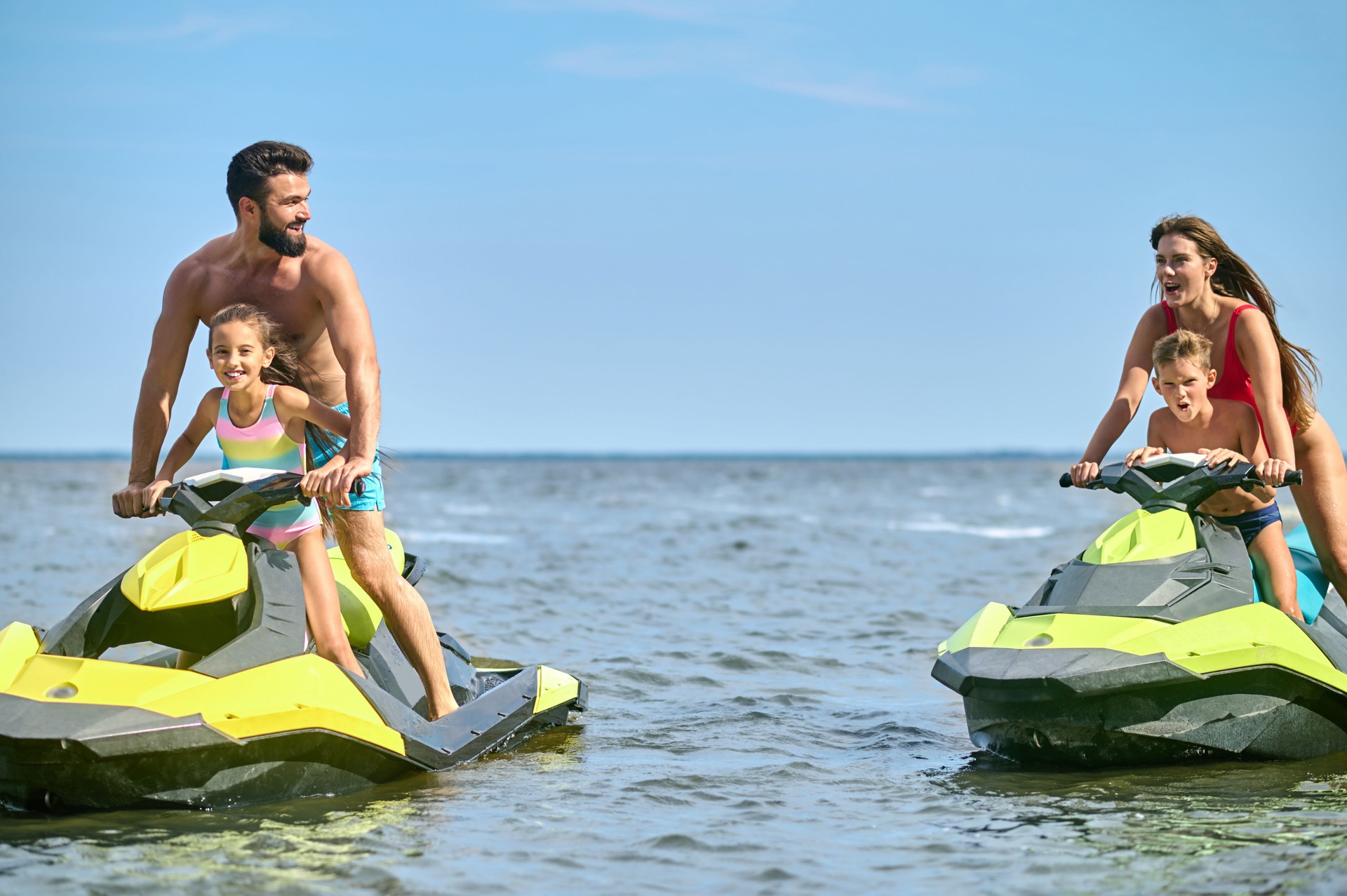 Family enjoyed active vacation outdoor sports and water recreation, jet-skiing on the water.